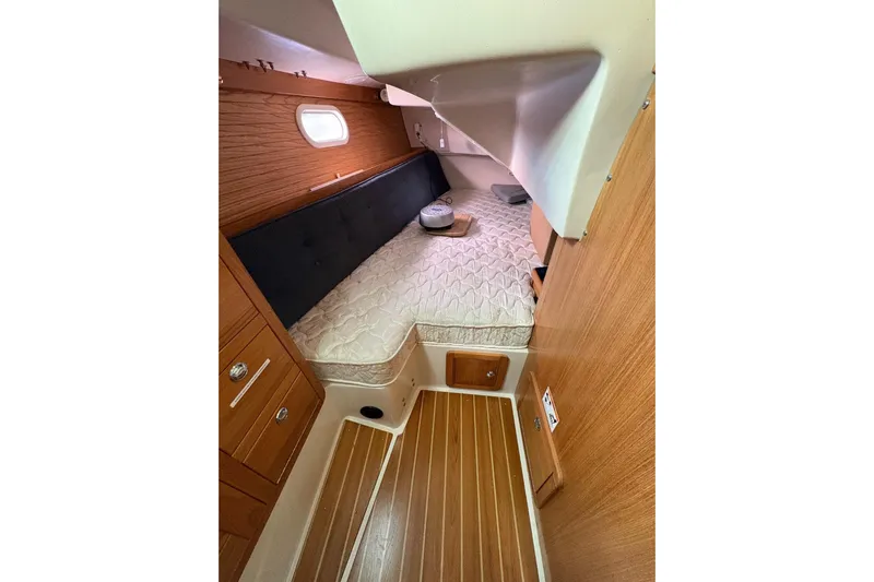 Kindred Spirit Yacht Photos Pics Cozy cabin interior of 2005 Catalina 36 MkII sailboat with wood paneling and bed.