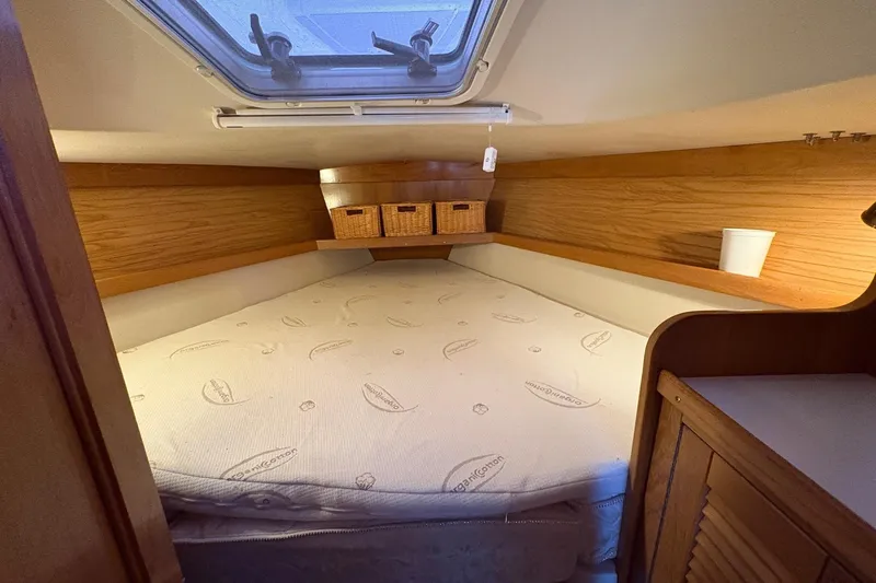 Kindred Spirit Yacht Photos Pics Cozy cabin interior of 2005 Catalina 36 MkII sailboat with bed and storage baskets.