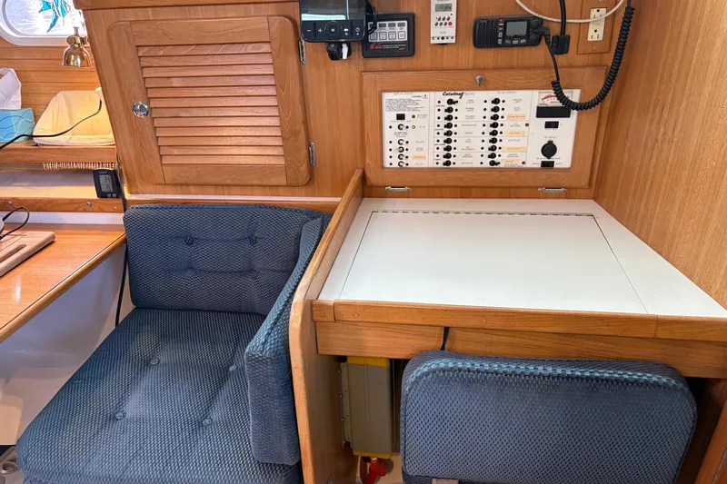 Kindred Spirit Yacht Photos Pics Navigation station in a 2005 Catalina 36 MkII sailboat with control panel and seating.