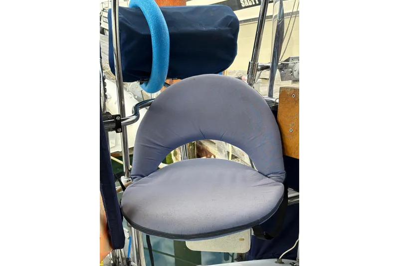 Kindred Spirit Yacht Photos Pics Captain's seat on a 2005 Catalina 36 MkII sailboat, featuring a cushioned backrest.