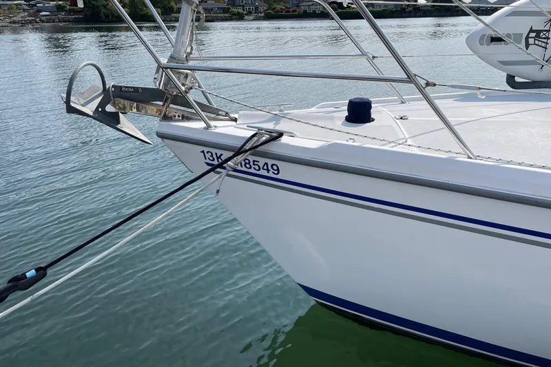 Kindred Spirit Yacht Photos Pics Catalina 36 MkII 2005 sailboat bow with anchor, docked on calm water.