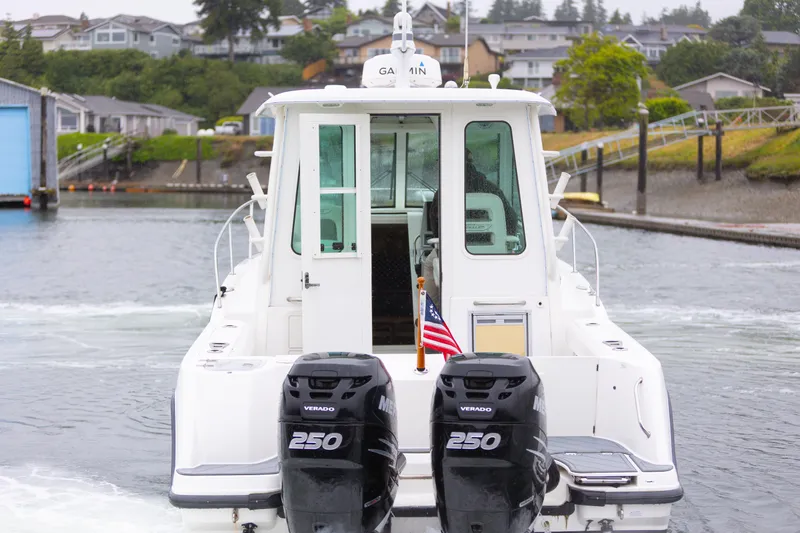 Boston Whaler 285 Yacht Photos Pics 2013 Boston Whaler 285 Conquest Pilothouse with twin 250 Verado engines, docked in a marina.