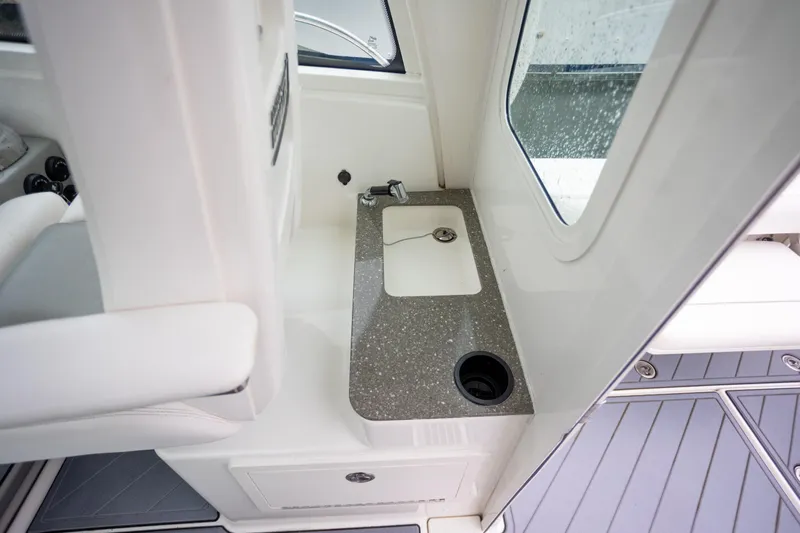 Boston Whaler 285 Yacht Photos Pics 2013 Boston Whaler 285 Conquest Pilothouse interior with sink and countertop.