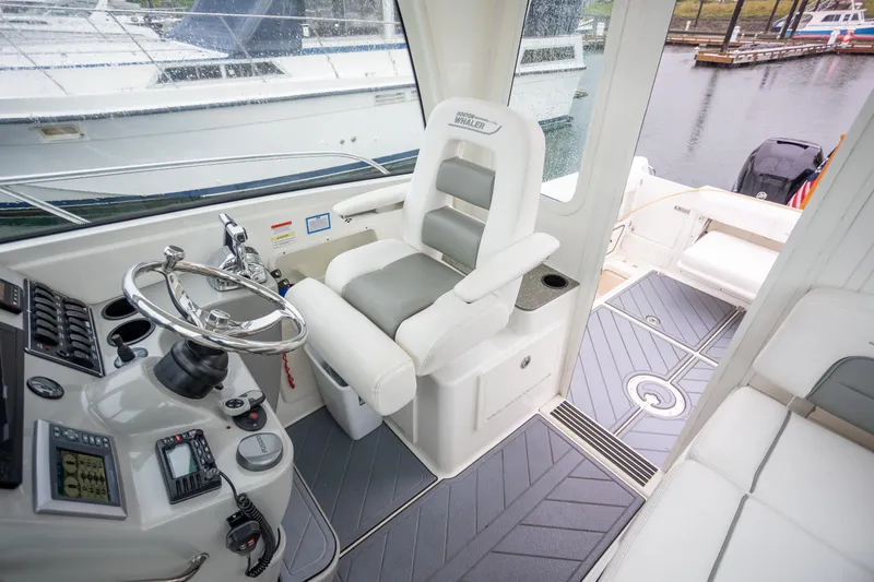 Boston Whaler 285 Yacht Photos Pics 2013 Boston Whaler 285 Conquest Pilothouse interior with helm, seating, and controls.