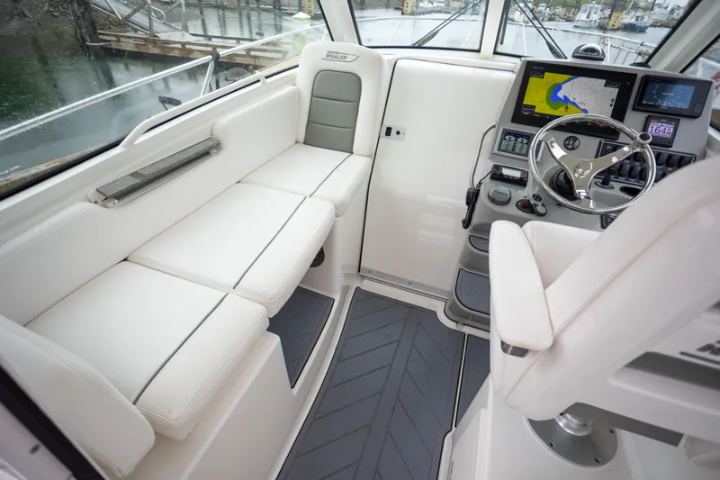 Boston Whaler 285 Yacht Photos Pics 2013 Boston Whaler 285 Conquest Pilothouse interior with seating and navigation controls.