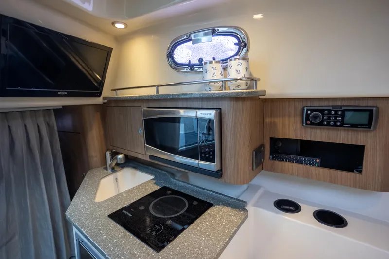 Boston Whaler 285 Yacht Photos Pics Interior of 2013 Boston Whaler 285 Conquest Pilothouse with kitchen amenities.