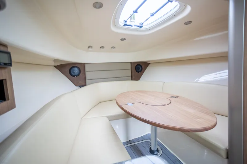 Boston Whaler 285 Yacht Photos Pics 2013 Boston Whaler 285 Conquest Pilothouse interior with seating and table.