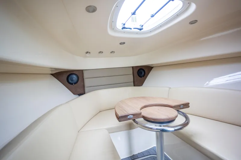 Boston Whaler 285 Yacht Photos Pics Interior of 2013 Boston Whaler 285 Conquest Pilothouse with seating and table.