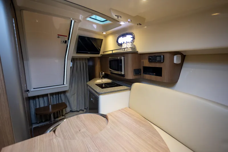 Boston Whaler 285 Yacht Photos Pics 2013 Boston Whaler 285 Conquest Pilothouse interior with kitchenette and seating area.