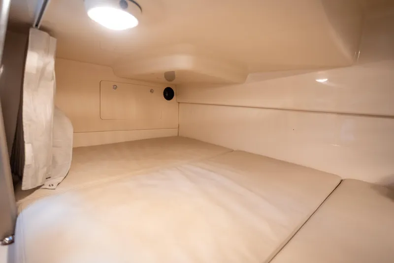 Boston Whaler 285 Yacht Photos Pics 2013 Boston Whaler 285 Conquest Pilothouse cabin interior with beige upholstery and lighting.