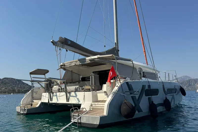  Yacht Photos Pics Modern 2021 Excess 15 catamaran anchored in scenic coastal waters.