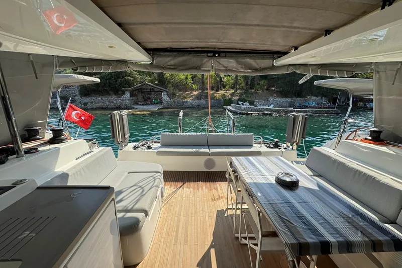  Yacht Photos Pics Luxurious 2021 Excess 15 yacht interior with Turkish flag, docked by serene waters.