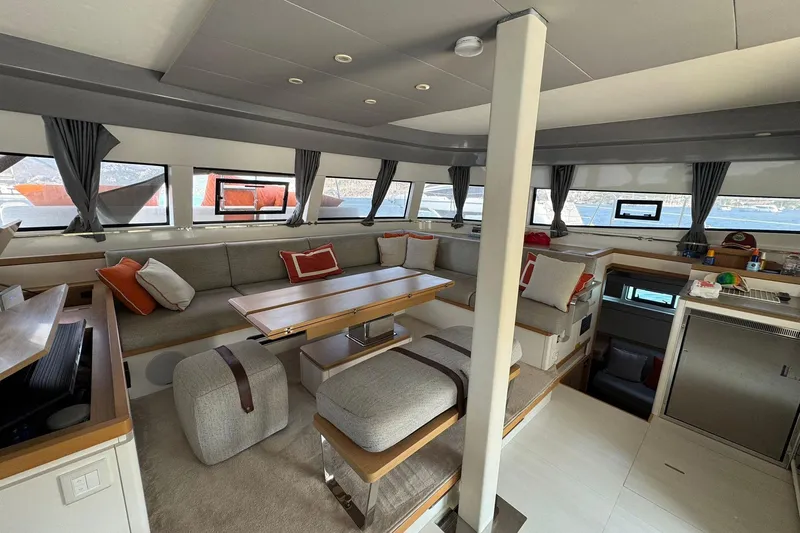  Yacht Photos Pics Luxurious interior of 2021 Excess 15 catamaran with modern seating and panoramic windows.