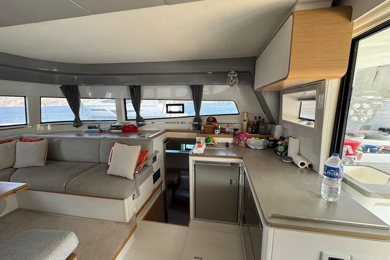  Yacht Photos Pics Luxurious interior of 2021 Excess 15 yacht with modern kitchen and seating area.