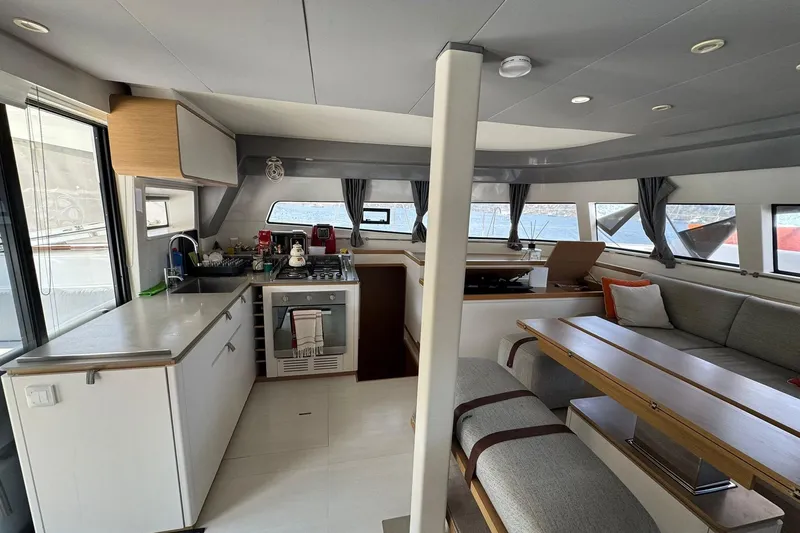  Yacht Photos Pics Modern interior of 2021 Excess 15 yacht with kitchen and seating area.