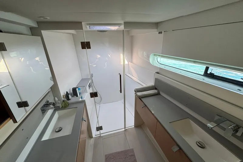  Yacht Photos Pics Luxurious bathroom interior on 2021 Excess 15 yacht with modern fixtures and ample lighting.