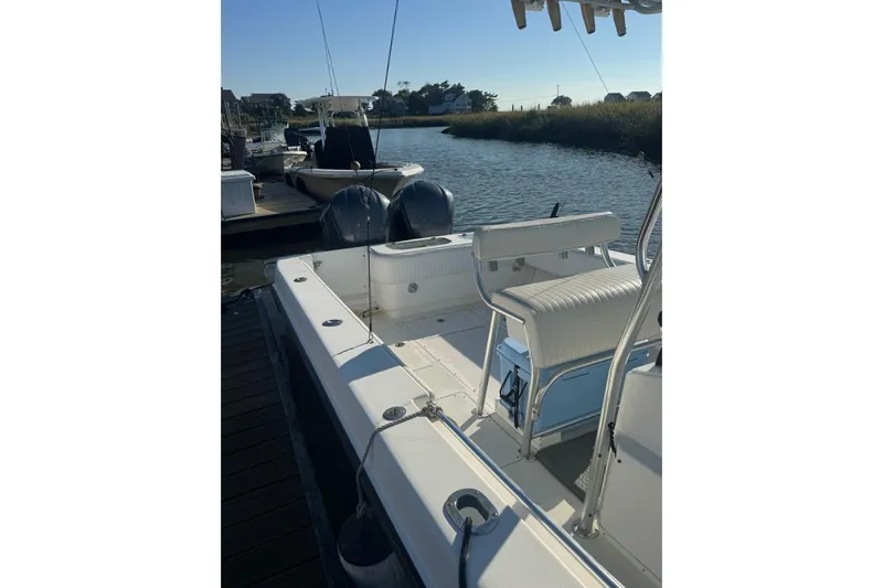 Elizabeth II Yacht Photos Pics 2001 Contender 31 Open boat docked by a serene waterfront.