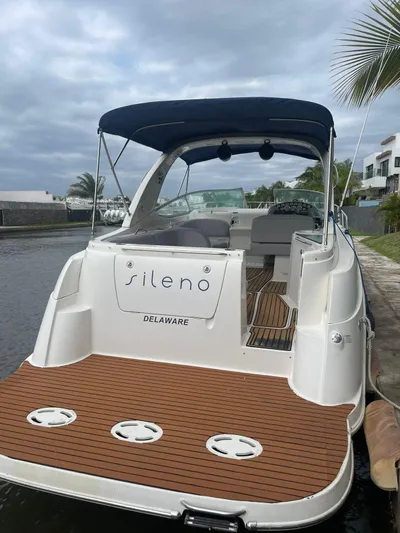 2012 Bayliner 335 Sb @ Veracruz Yacht Photos Pics 2012 Bayliner 335 Cruiser docked, featuring sleek design and spacious deck under a cloudy sky.