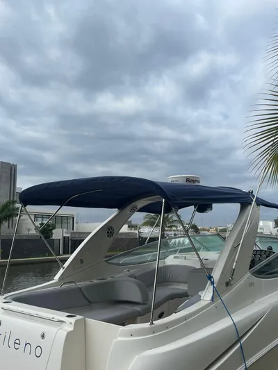 2012 Bayliner 335 Sb @ Veracruz Yacht Photos Pics 2012 Bayliner 335 Cruiser docked under cloudy skies, featuring a blue canopy.