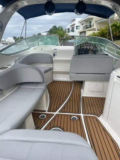 2012 Bayliner 335 Sb @ Veracruz Yacht Photos Pics 2012 Bayliner 335 Cruiser with sleek interior and wooden deck, docked near modern homes.