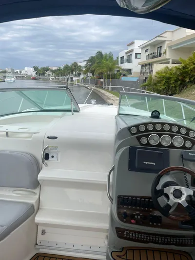 2012 Bayliner 335 Sb @ Veracruz Yacht Photos Pics 2012 Bayliner 335 Cruiser cockpit with modern controls, docked near waterfront homes.