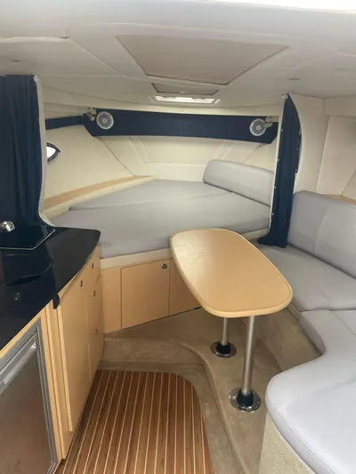 2012 Bayliner 335 Sb @ Veracruz Yacht Photos Pics Interior of a 2012 Bayliner 335 Cruiser with seating, table, and kitchenette.