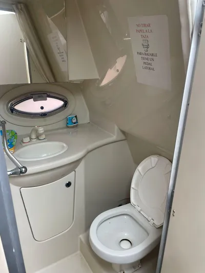 2012 Bayliner 335 Sb @ Veracruz Yacht Photos Pics 2012 Bayliner 335 Cruiser bathroom with sink, toilet, and oval window.