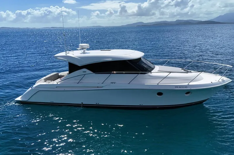 Yacht Photos Pics 2022 Tiara Yachts C39 Coupe cruising on clear blue ocean waters.