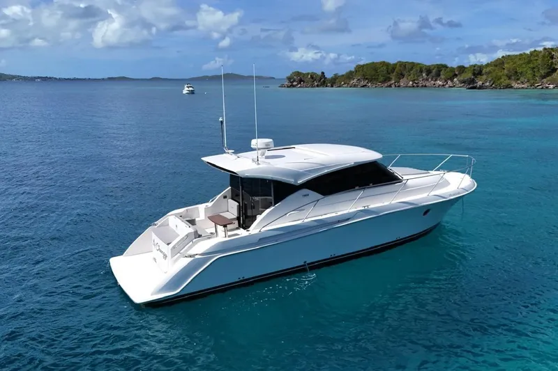  Yacht Photos Pics 2022 Tiara Yachts C39 Coupe cruising on clear blue waters.