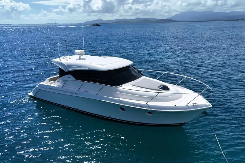  Yacht Photos Pics 2022 Tiara Yachts C39 Coupe cruising on clear blue ocean waters.