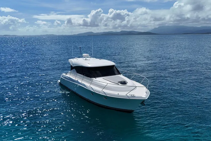  Yacht Photos Pics 2022 Tiara Yachts C39 Coupe cruising on clear blue ocean waters.