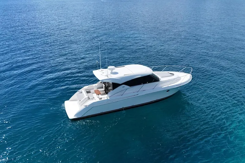  Yacht Photos Pics 2022 Tiara Yachts C39 Coupe cruising on clear blue water.