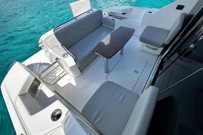  Yacht Photos Pics 2022 Tiara Yachts C39 Coupe cockpit with seating and table, overlooking clear blue water.