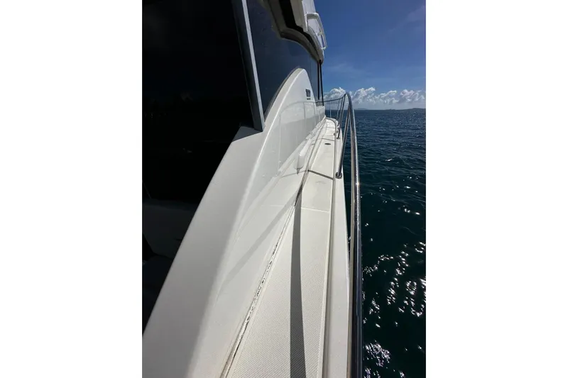  Yacht Photos Pics 2022 Tiara Yachts C39 Coupe cruising on open water under clear skies.