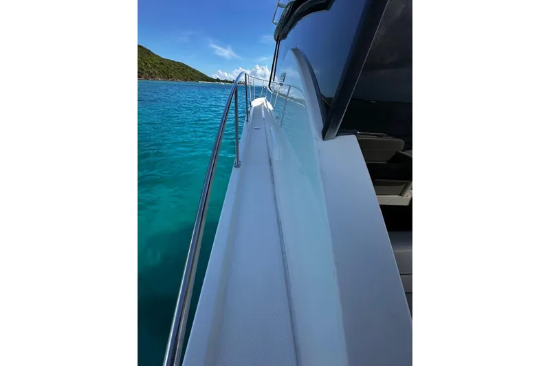  Yacht Photos Pics 2022 Tiara Yachts C39 Coupe on clear blue water, side view.