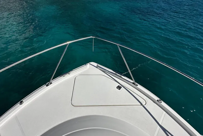  Yacht Photos Pics Bow view of 2022 Tiara Yachts C39 Coupe on clear blue water.