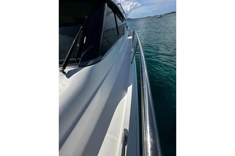  Yacht Photos Pics 2022 Tiara Yachts C39 Coupe cruising on clear blue water.