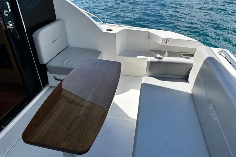  Yacht Photos Pics Luxurious seating area on 2022 Tiara Yachts C39 Coupe, overlooking serene ocean waters.