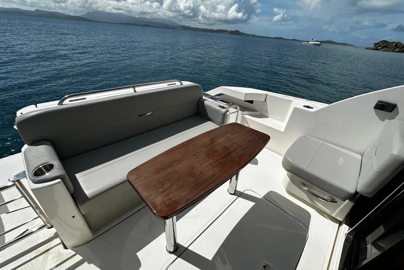  Yacht Photos Pics 2022 Tiara Yachts C39 Coupe deck with seating and table, overlooking serene ocean view.