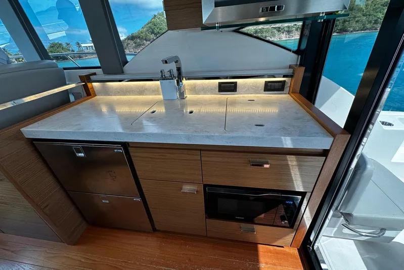  Yacht Photos Pics Modern kitchen area in 2022 Tiara Yachts C39 Coupe with sleek countertops and appliances.