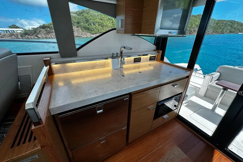  Yacht Photos Pics Luxurious 2022 Tiara Yachts C39 Coupe interior with modern kitchen and scenic ocean view.