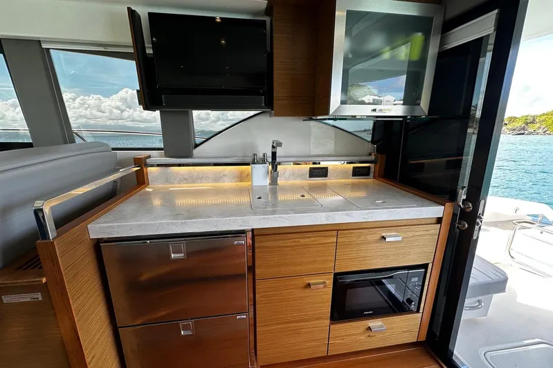  Yacht Photos Pics Modern kitchen interior of 2022 Tiara Yachts C39 Coupe with ocean view.