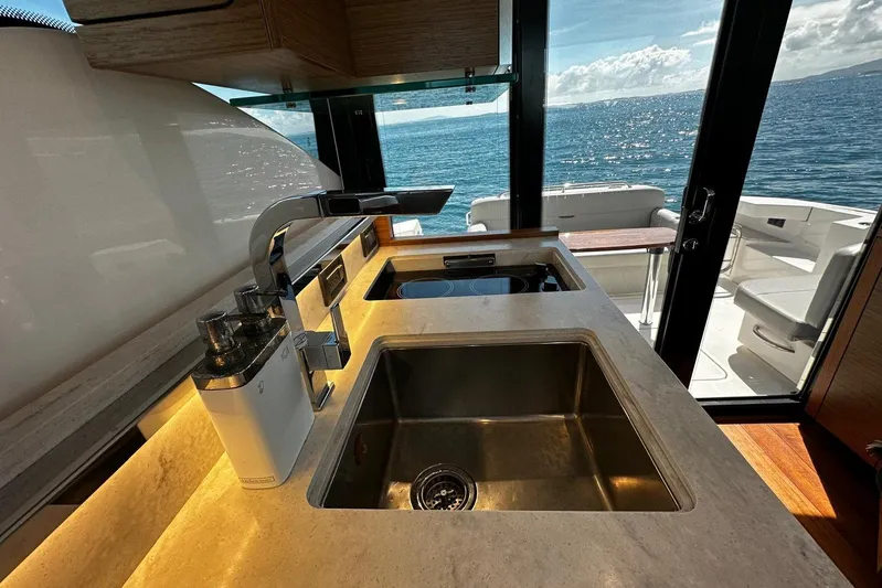 Yacht Photos Pics Modern kitchen interior of 2022 Tiara Yachts C39 Coupe with ocean view.