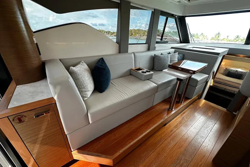  Yacht Photos Pics Luxurious interior of 2022 Tiara Yachts C39 Coupe with elegant seating and wooden flooring.