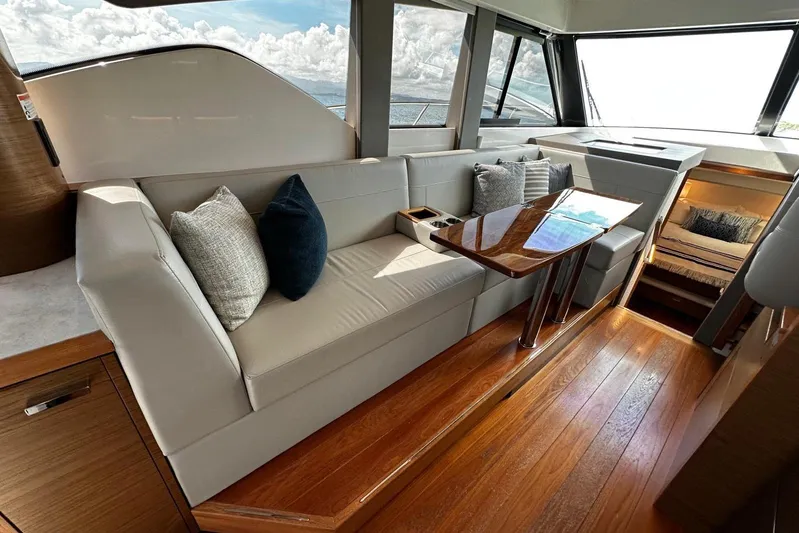  Yacht Photos Pics Luxurious interior of 2022 Tiara Yachts C39 Coupe with elegant seating and wooden flooring.