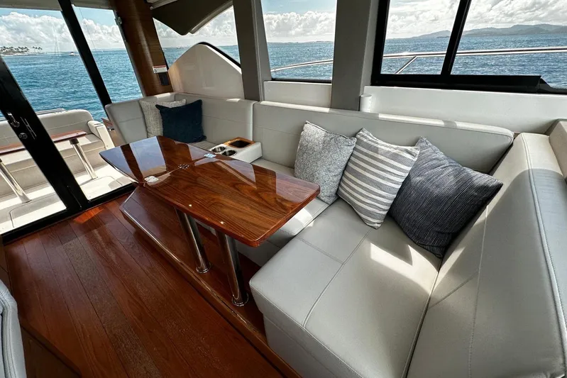  Yacht Photos Pics 2022 Tiara Yachts C39 Coupe interior with elegant seating and wooden table, ocean view.