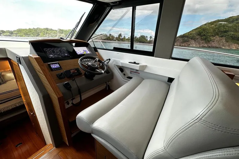  Yacht Photos Pics 2022 Tiara Yachts C39 Coupe helm with modern controls and scenic ocean view.