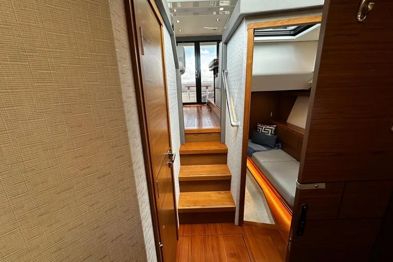  Yacht Photos Pics Interior of 2022 Tiara Yachts C39 Coupe, featuring wooden stairs and cozy cabin.