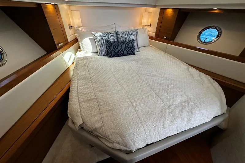  Yacht Photos Pics Luxurious bedroom interior of 2022 Tiara Yachts C39 Coupe with elegant bedding.