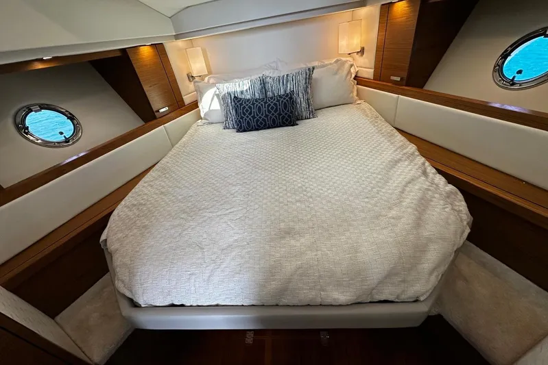  Yacht Photos Pics Luxurious bedroom interior of 2022 Tiara Yachts C39 Coupe with elegant bedding.